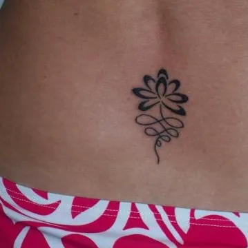 Real community tattoo placement: Claire - lotus lower back