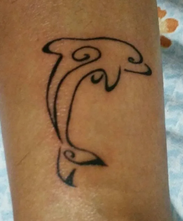 Real community tattoo placement: Enna  - stylized dolphin