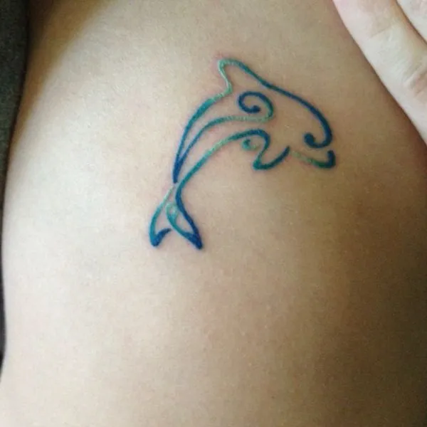 Real community tattoo placement: Guest - stylized dolphin