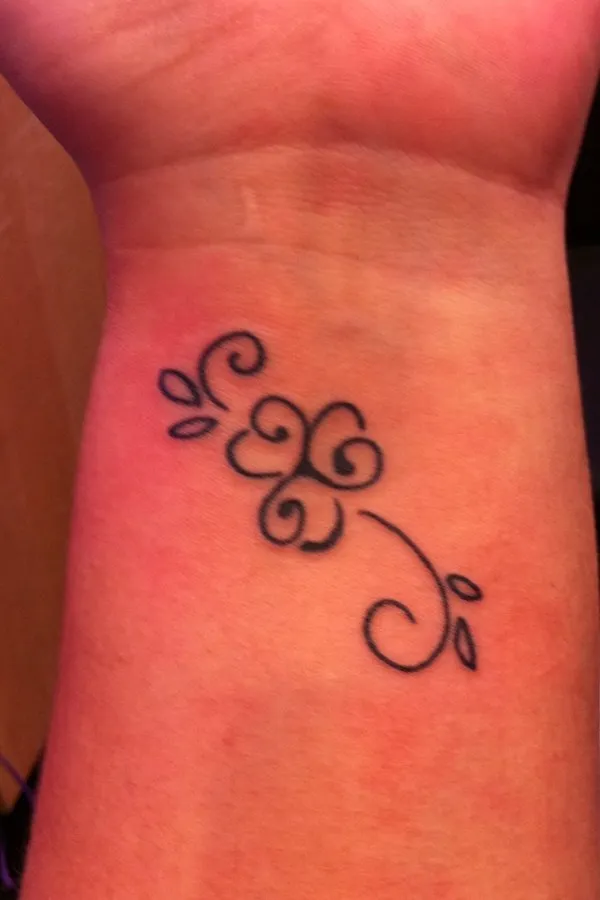 Real community tattoo placement: Jen - Triskell clover