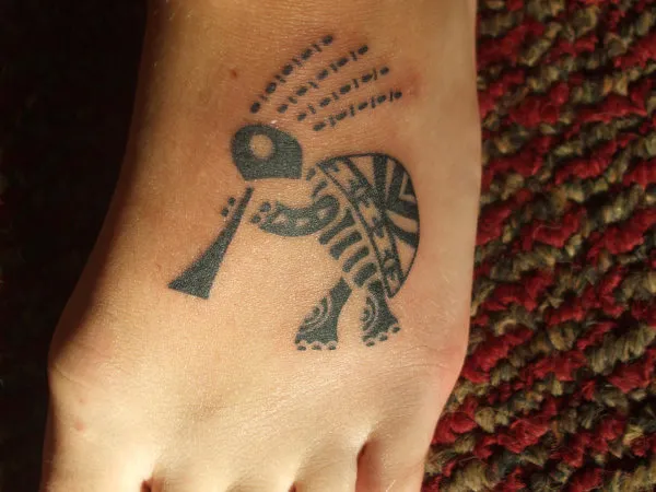Real community tattoo placement: Kylie - kokopelli turtle