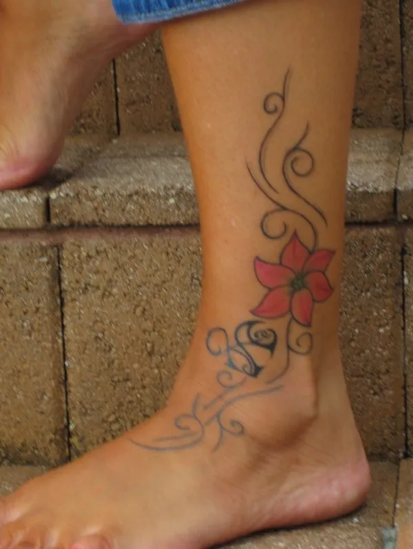 Real community tattoo placement: Rebecca - Heartigram and flowers