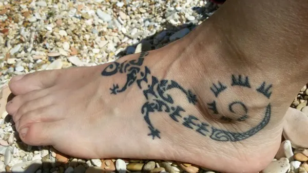 Real community tattoo placement: Silvia - lizard and sun
