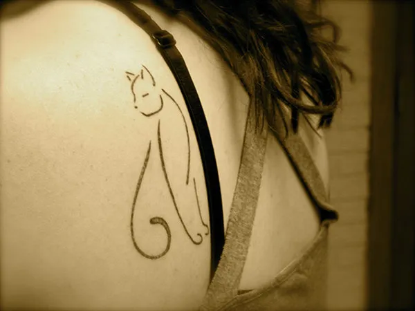 Real community tattoo placement: Snoopy - Stylized cat
