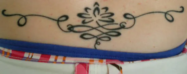 Real community tattoo placement: Tina - Lotus lower back