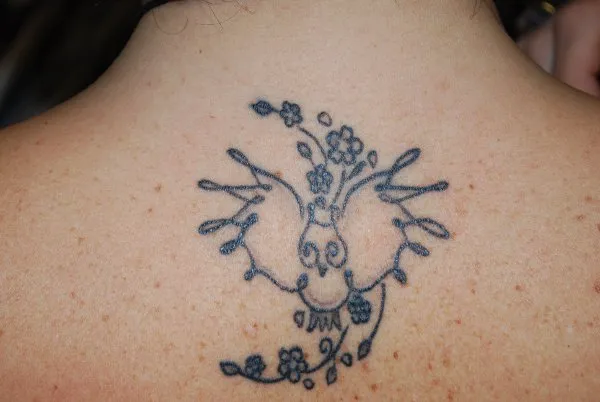Real community tattoo placement: Tiziana - Owl and cherry blossoms