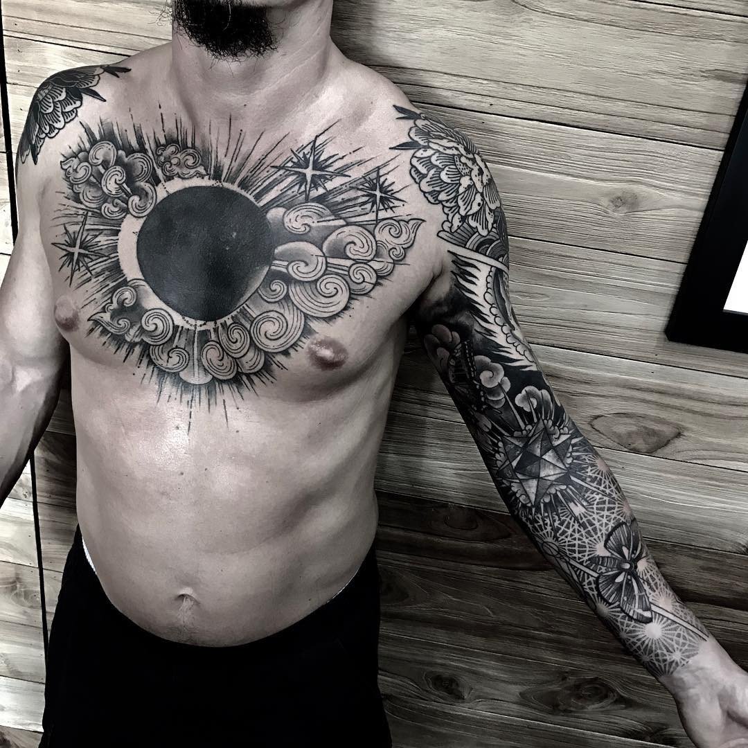 Chest blackwork tattoo with moon eclipse among clouds: inked placement real user tattoo photo