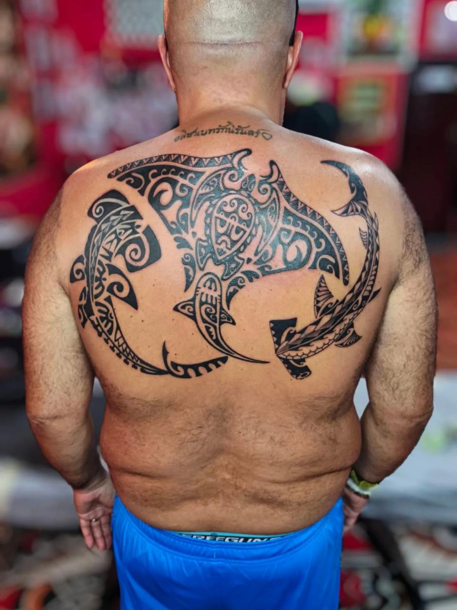 Polynesian back piece comprising a manta and two hammerhead sharks: inked placement tattoo photo