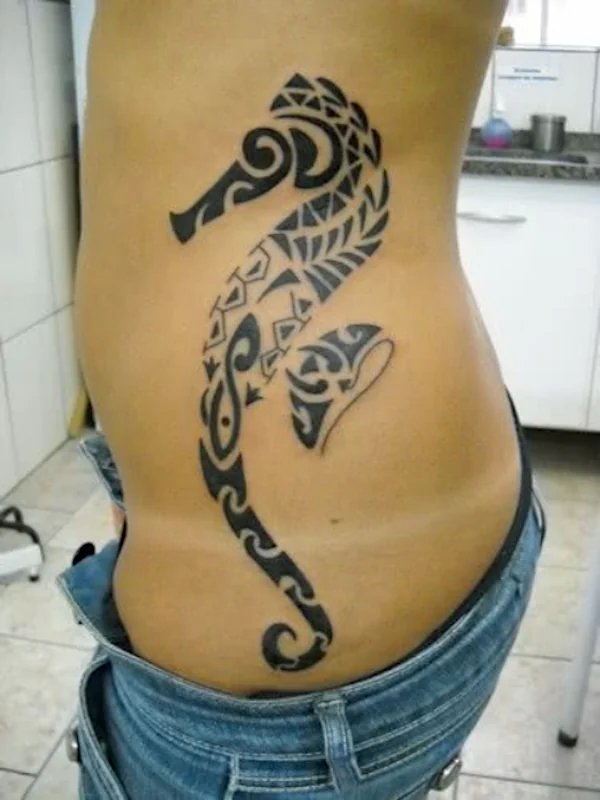 Photo of a large Polynesian style seahorse tattoo on the side of a girls hip: inked placement real user tattoo photo
