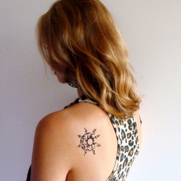 Small tribal sun-moon tattoo behind the shoulder: inked placement real user tattoo photo