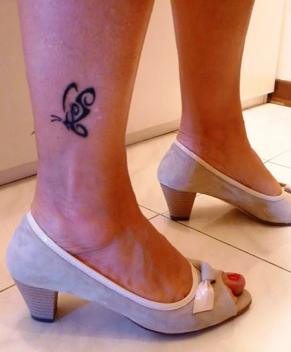 Real community tattoo placement: Sara - S+L butterfly