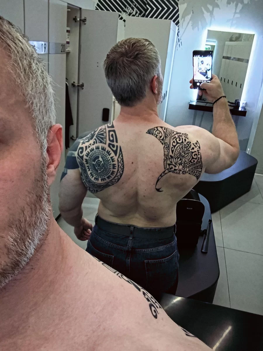 Polynesian manta tattoo on shoulder blade