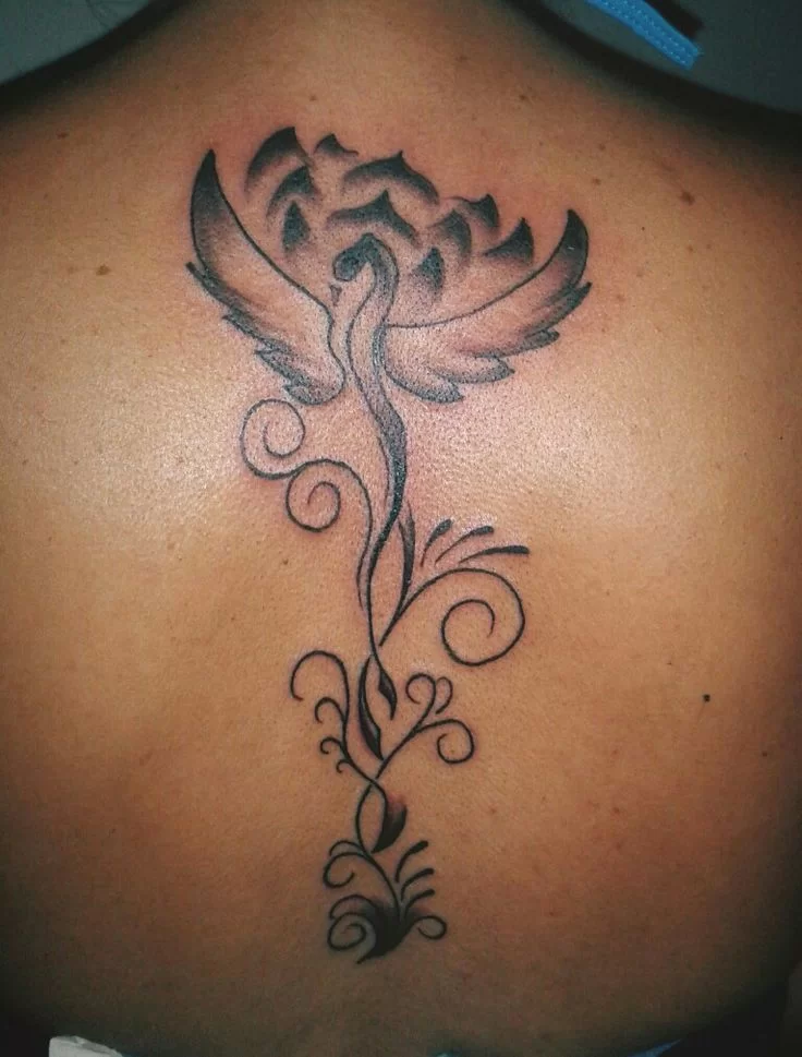 Yaxili - phoenix and lotus tattoo on the back along the spine